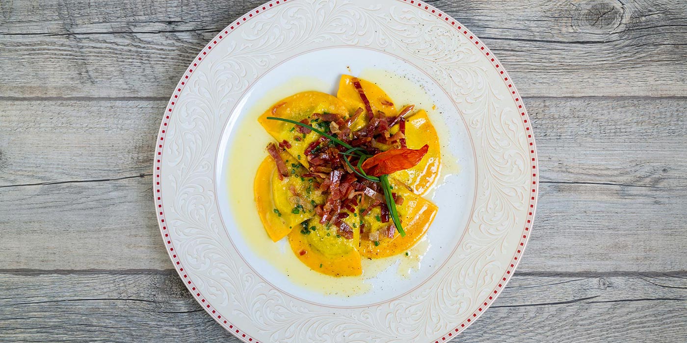 Ravioli dish with butter and speck